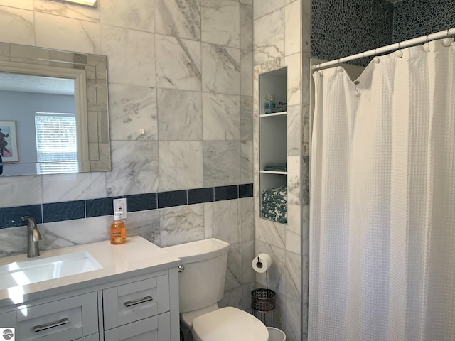 2708 Ruby St, Traverse City, MI 49684 - bathroom featuring tile walls, vanity, toilet, and a shower with shower curtain