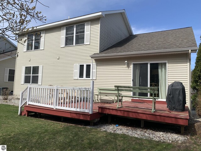 2708 Ruby St, Traverse City, MI 49684 - back of property with a yard, a deck, and roof with shingles