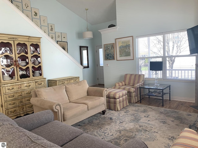2708 Ruby St, Traverse City, MI 49684 - living area with high vaulted ceiling, wood finished floors, baseboards, healthy amount of natural light, and stairs