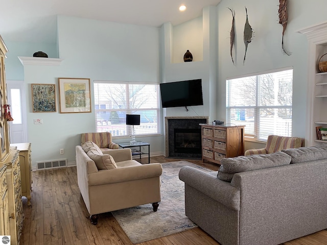 2708 Ruby St, Traverse City, MI 49684 - living room featuring a high ceiling, a fireplace with flush hearth, plenty of natural light, wood finished floors, and recessed lighting