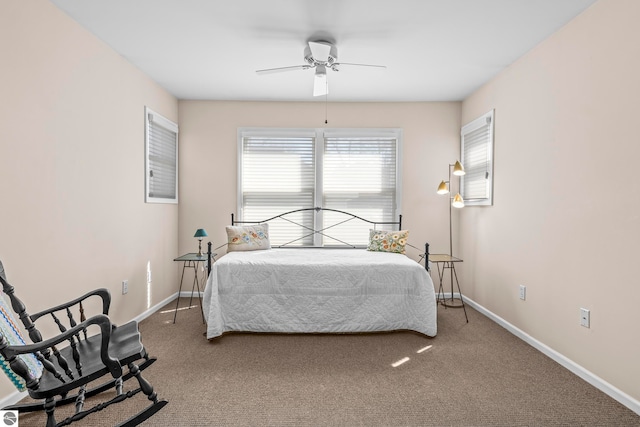 carpeted bedroom with a ceiling fan and baseboards