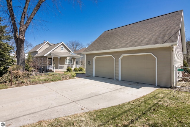 view of front of home with a garage, a shingled roof, and covered porch