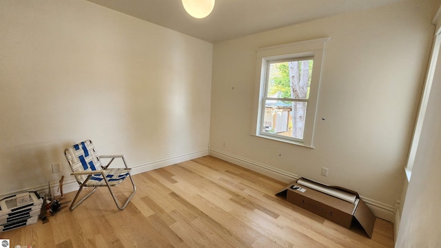 empty room featuring baseboards and wood finished floors