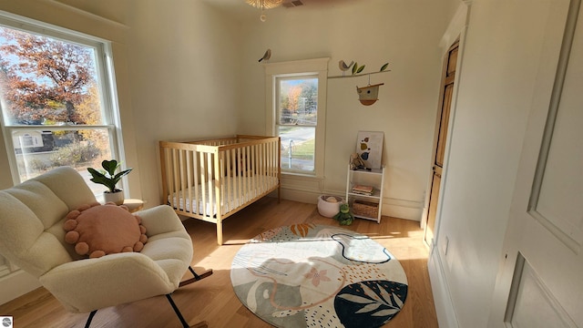 bedroom with multiple windows, wood finished floors, and visible vents