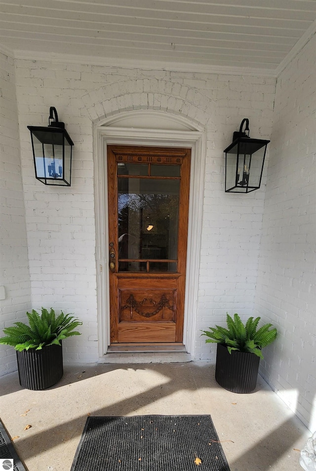 doorway to property with brick siding