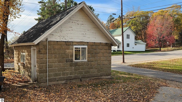 view of side of home featuring an outbuilding