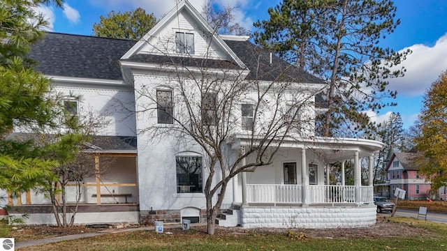 view of front of property featuring covered porch and roof with shingles
