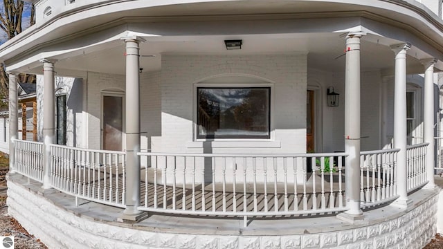 exterior space with brick siding and a porch