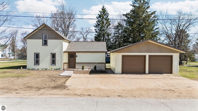 419 S Cherry St, Kalkaska, MI 49646 - traditional home featuring an outdoor structure, roof with shingles, and a garage