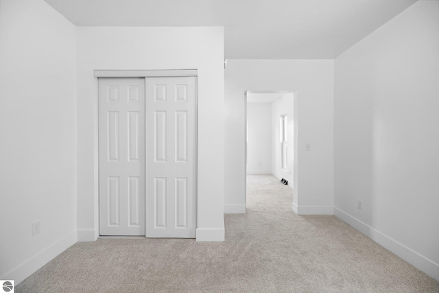 419 S Cherry St, Kalkaska, MI 49646 - unfurnished bedroom featuring baseboards, carpet flooring, and a closet
