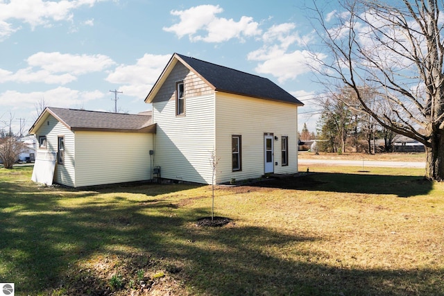 419 S Cherry St, Kalkaska, MI 49646 - view of side of property featuring a lawn and a shingled roof