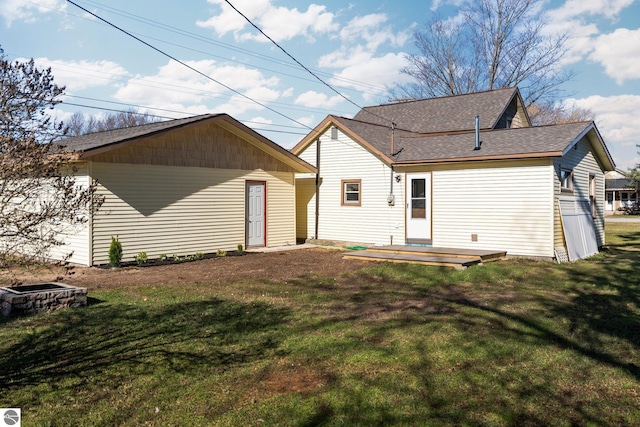 419 S Cherry St, Kalkaska, MI 49646 - rear view of property with a wooden deck, a yard, and a shingled roof