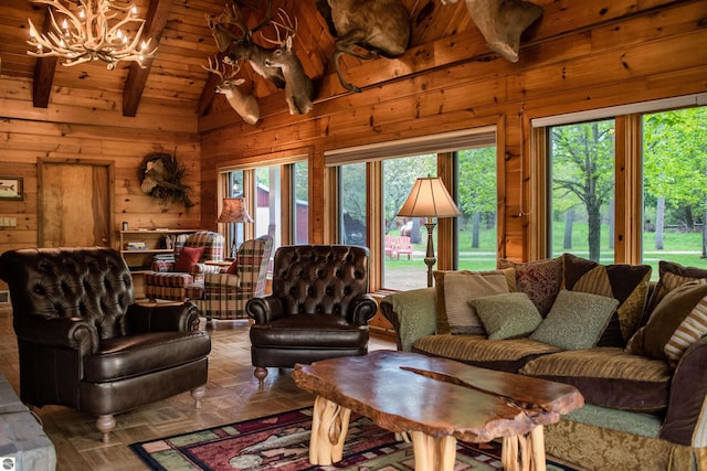living area featuring a chandelier, wooden walls, wooden ceiling, and lofted ceiling with beams