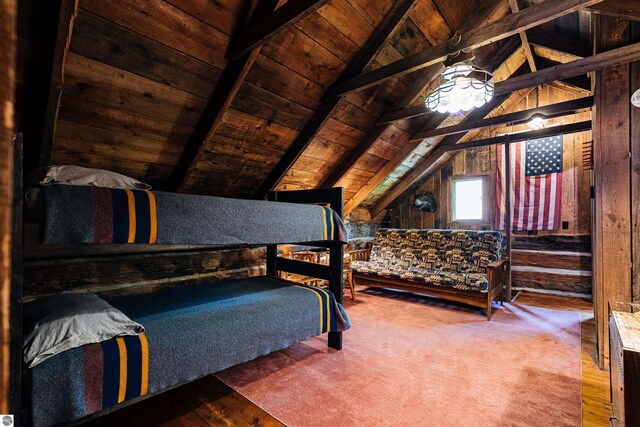bedroom with wood ceiling, lofted ceiling with beams, wood walls, and hardwood / wood-style floors