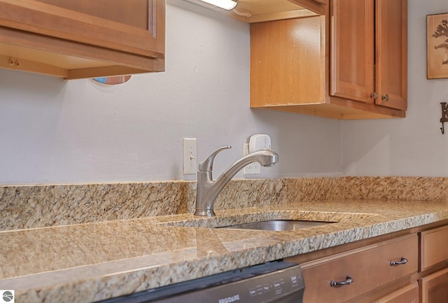 interior details featuring a sink and brown cabinetry
