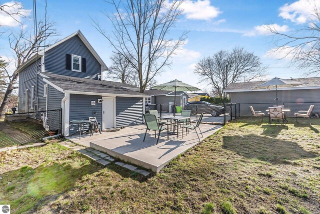 view of yard featuring a fenced backyard, a patio area, and a gate