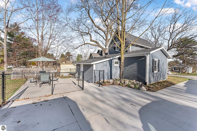 view of side of property with a gate and fence