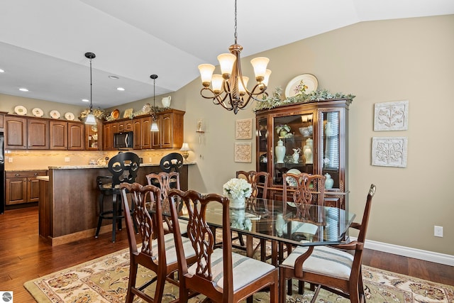 4584 Kodiak Dr, Traverse City, MI 49685 - dining space featuring a notable chandelier, baseboards, lofted ceiling, dark wood-style floors, and recessed lighting