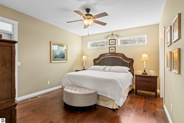 4584 Kodiak Dr, Traverse City, MI 49685 - bedroom with dark wood-type flooring, visible vents, baseboards, and multiple windows