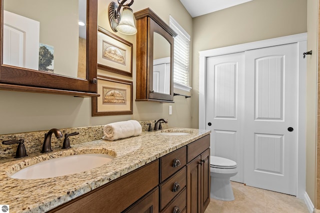 4584 Kodiak Dr, Traverse City, MI 49685 - full bath featuring toilet, tile patterned flooring, a sink, and double vanity