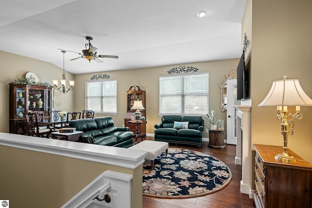 4584 Kodiak Dr, Traverse City, MI 49685 - living room featuring dark wood finished floors, baseboards, and ceiling fan with notable chandelier