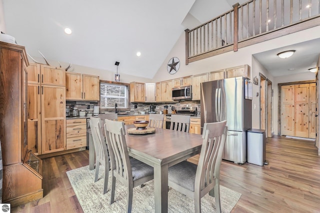 5891 Voice Rd, Kingsley, MI 49649 - dining space with high vaulted ceiling, wood finished floors, and recessed lighting