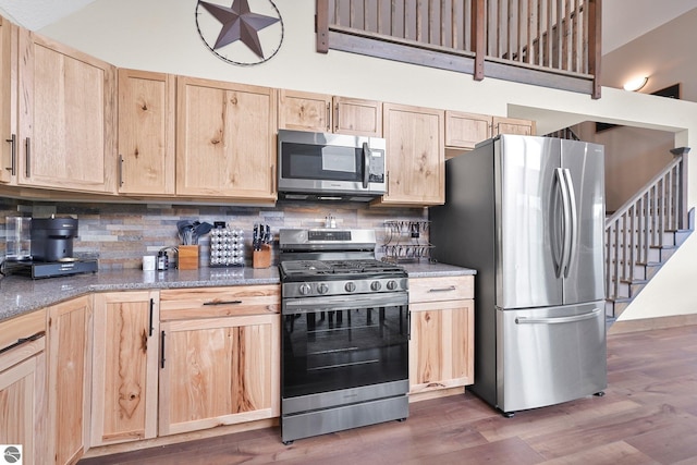 5891 Voice Rd, Kingsley, MI 49649 - kitchen featuring dark wood finished floors, backsplash, light brown cabinetry, and stainless steel appliances