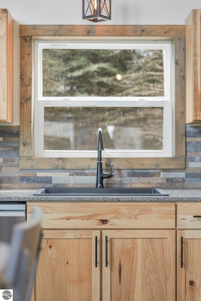 5891 Voice Rd, Kingsley, MI 49649 - bar featuring stainless steel dishwasher, a sink, and backsplash