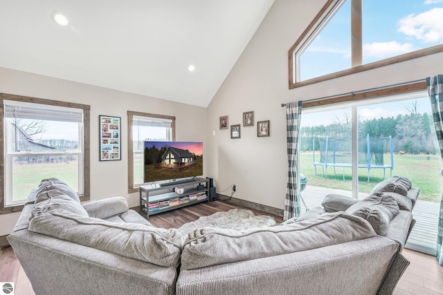 5891 Voice Rd, Kingsley, MI 49649 - living area with recessed lighting, wood finished floors, baseboards, and high vaulted ceiling