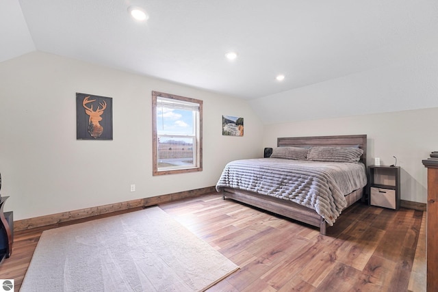 5891 Voice Rd, Kingsley, MI 49649 - bedroom with lofted ceiling, baseboards, wood finished floors, and recessed lighting