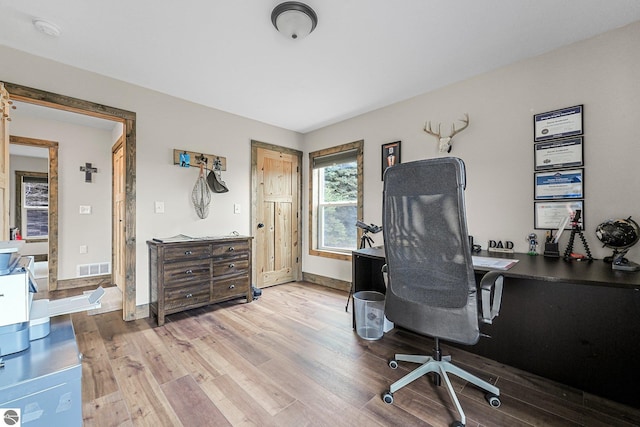 5891 Voice Rd, Kingsley, MI 49649 - office space featuring wood finished floors, visible vents, and baseboards