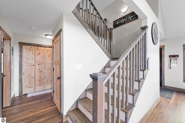5891 Voice Rd, Kingsley, MI 49649 - staircase featuring baseboards and hardwood / wood-style flooring
