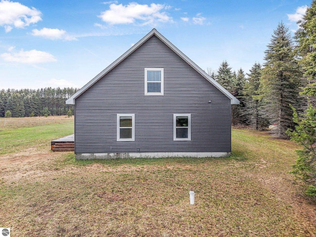 5891 Voice Rd, Kingsley, MI 49649 - view of side of home featuring a yard and a wooded view