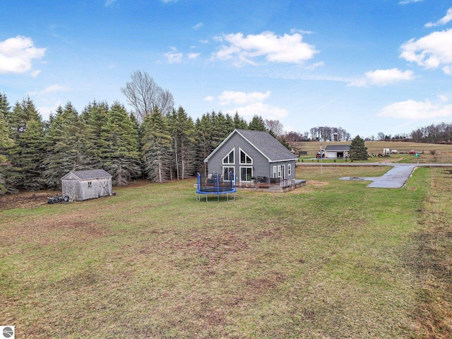 5891 Voice Rd, Kingsley, MI 49649 - view of yard with a storage unit, an outdoor structure, and a trampoline