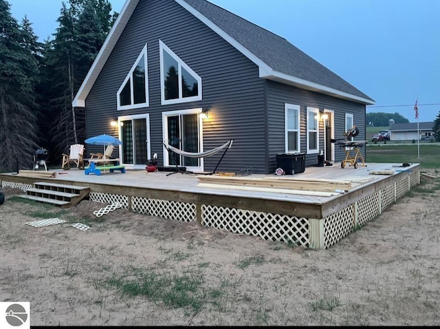 5891 Voice Rd, Kingsley, MI 49649 - rear view of house with roof with shingles and a deck