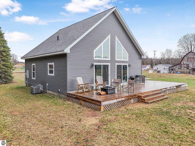 5891 Voice Rd, Kingsley, MI 49649 - rear view of property featuring a lawn, a wooden deck, cooling unit, and a shingled roof