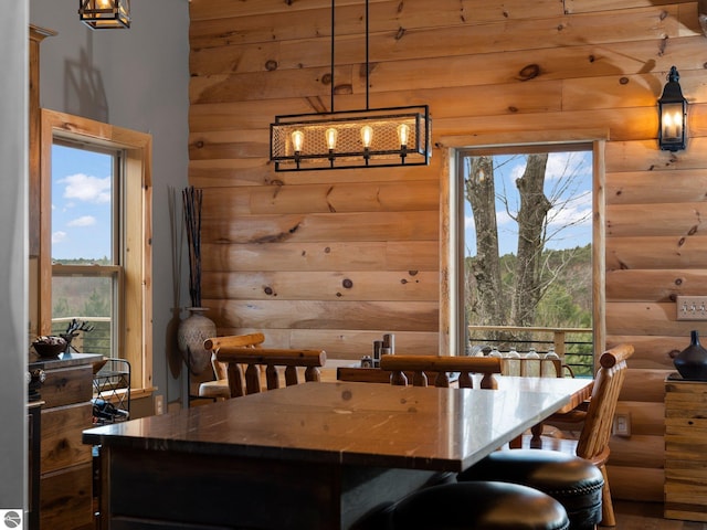 5242 W Big Sky Trl, Cadillac, MI 49601 - dining room featuring log walls and a chandelier