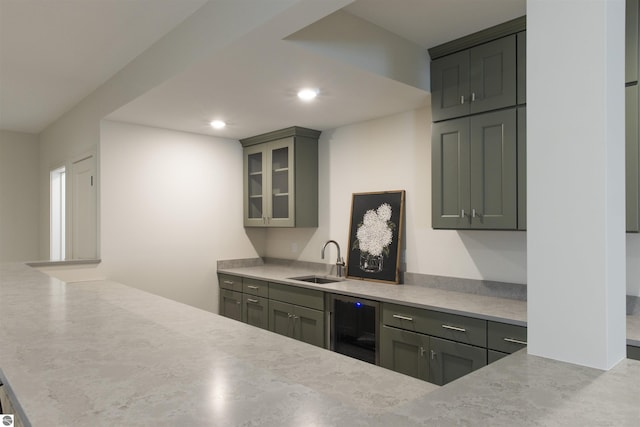 203 Vineyard Ridge Dr Unit 38, Traverse City, MI 49686 - kitchen featuring recessed lighting, beverage cooler, a sink, a peninsula, and glass insert cabinets