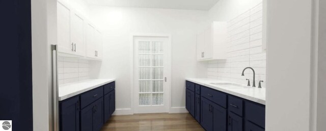 bathroom with backsplash, vanity, and wood finished floors