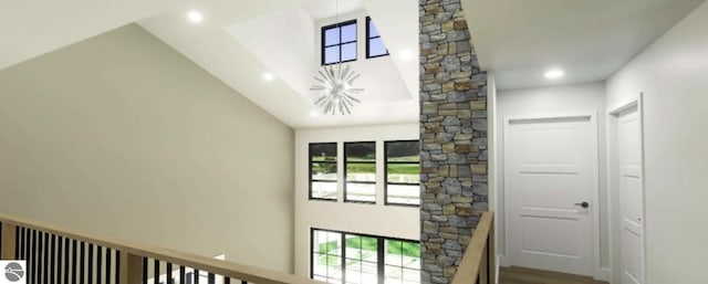 doorway to outside featuring a high ceiling, recessed lighting, a chandelier, and wood finished floors