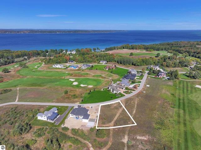 aerial overview of property's location featuring a nearby body of water and a golf course