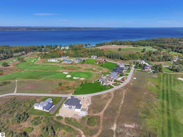 view of property location featuring a large body of water and a local golf course