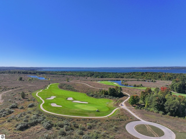 bird's eye view of a nearby body of water and a local golf course