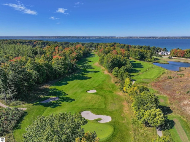 view of property location featuring a large body of water and a local golf course
