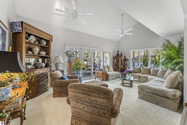 living room featuring plenty of natural light, carpet, ceiling fan, and high vaulted ceiling