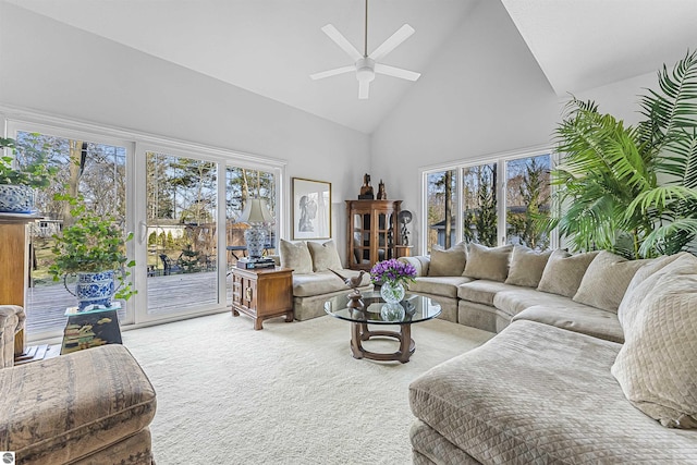 living room featuring high vaulted ceiling, ceiling fan, plenty of natural light, and carpet