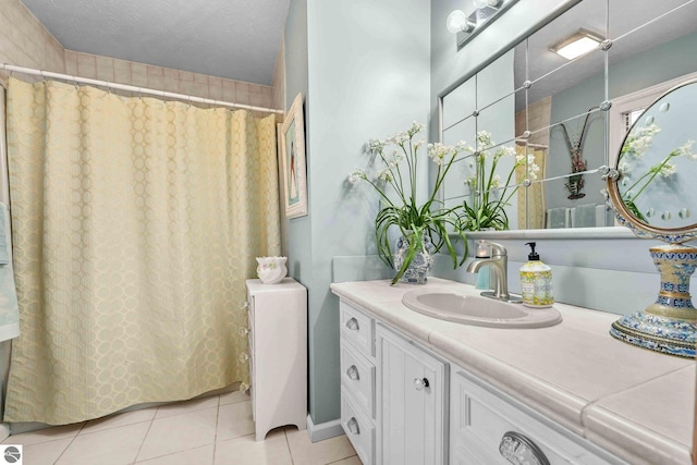 bathroom featuring a shower with curtain, vanity, and tile patterned floors