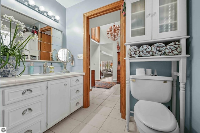 bathroom with vanity, toilet, and tile patterned flooring