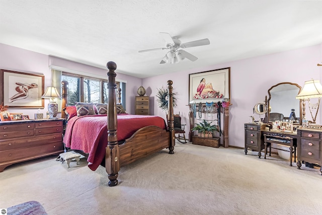 bedroom with light colored carpet, ceiling fan, and baseboards