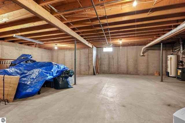 unfinished basement featuring water heater